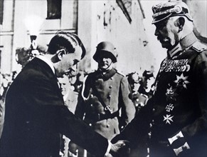 Paul von Hindenburg shaking hands with Adolf Hitler