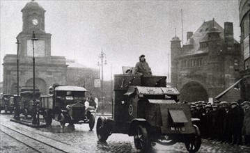 an armoured car escorting a convoy of vehicles in London during the General Strike