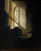 A Man seated reading at a Table in a Lofty Room'