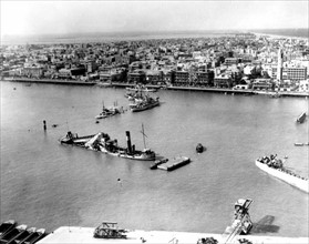 Photograph of scuttled ships blocking the entrance to the Suez canal at Port Said