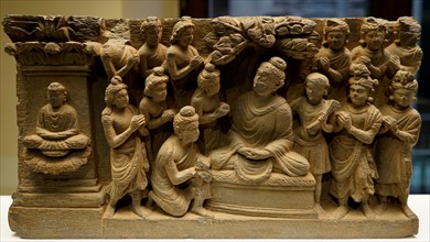 Gandhara Buddha accompanied by devotees