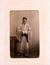 Studio portrait of a Chinese Buddhist priest