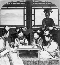 Manchurian ladies at tea and cards, Peking, China 1902.