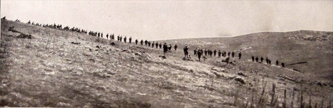 Serbian infantry take up position on a hillside.