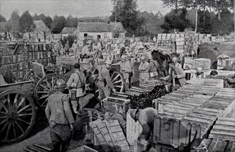 French soldiers load cases of supplies and ammunition.