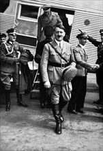 Adolf Hitler arriving at an airfield in Germany accompanied by Dr Josef Goebbels