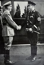Adolf Hitler is met by Richard Walther Darré