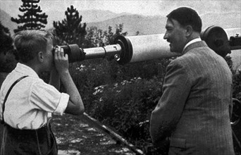 Adolf Hitler with a young boy at his mountain retreat