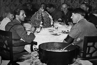 Adolf Hitler arriving at meal in the Chancellery, accompanied by Dr Josef Goebbels