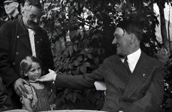 Adolf Hitler greets a young girl