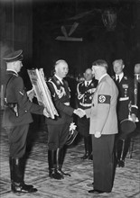 Adolf Hitler presented with a painting from SS Chief Heinrich Himmler, circa 1937.