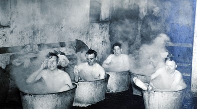 British soldiers from the Dorset shire regiment bath in metal tubs