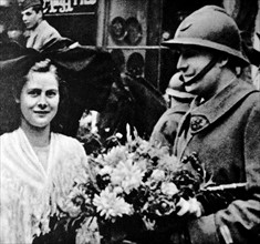 World War Two: French soldier receives flowers from a woman in Alsace Lorraine. 1940
