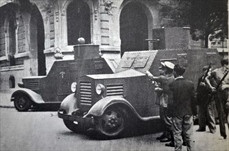 Two armoured cars protect Republican soldiers during street fighting in Barcelona