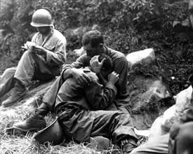Korean War 1953. American soldier comforts another soldier in distress