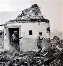 WWII: American soldiers advance building by building through villages