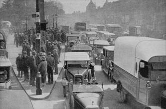 London traffic crowds the roads of the British capital during the nineteen twenties.