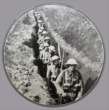 British soldiers pass through a link trench on the western front during WWI 1915