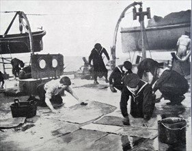 Sailors wash clothes on deck on a British naval ship during WWI 1916