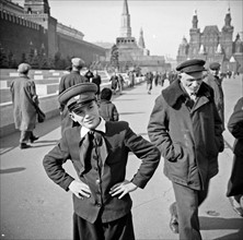 Boy in school uniform, stood at the red square, in Moscow.