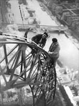 Electricians working on the mantainence of the Eiffel Tower.