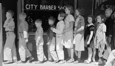 Schoolchildren waiting in line to go to the movies, San Augustine, Texas