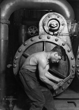 Photograph of Mechanic working on steam pump