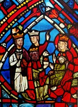 Stained glass window depicting the adoration of the Magi. Dated 13th century.