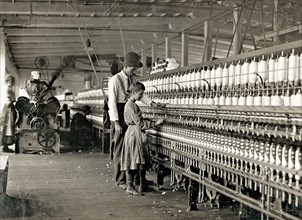 Photograph of Young girl working as a spinner