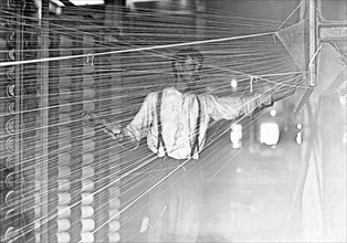 Photograph of a wrapper working at his machine