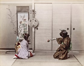Colour Photograph of two Japanese girls playing with a ball