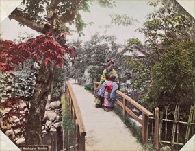 Colour Photograph of two Japanese girls in a traditional Garden