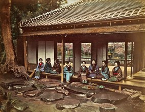Colour photograph of a Japanese Tea House with girls waiting to attend clients