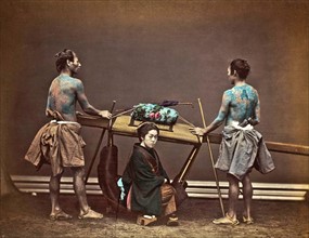 Colour photograph of a Japanese women in basket palanquin