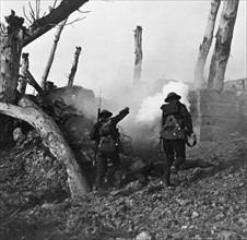 Photograph of American soldiers advancing on a German bunker position