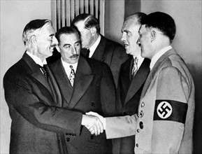 Adolf Hitler greets British Prime Minister Neville chamberlain at Munich 1938