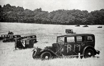Photograph of abandoned motor vehicles in a field