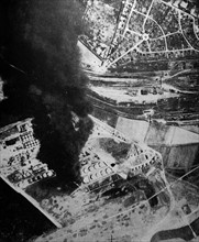 Photograph of a cloud of dense smoke where an oil tank had been destroyed by the R.A.F. at Dunkirk