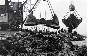 dredging silt to create a dam in Holland 1932