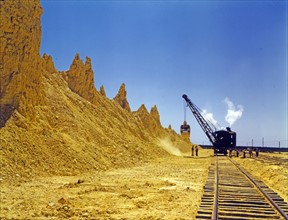 Nearly exhausted sulphur vat from which railroad cars are loaded