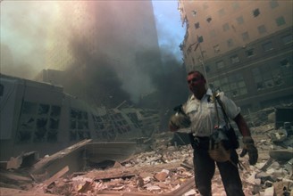 Colour photograph of a New York rescuer worker amid the rubble of the World Trade Centre following the 9/11 attacks