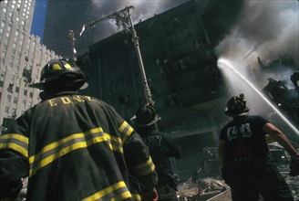 Colour photograph of a New York Fire-fighter amid the rubble of the World Trade Centre following the 9/11 attacks