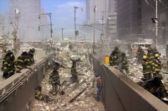 Colour photograph of New York Firefighters amid the rubble of the World Trade Centre following the 9/11 attacks