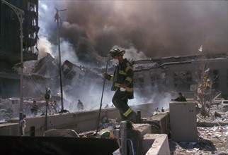Colour photograph of New York Firefighters amid the rubble of the World Trade Centre following the 9/11 attacks