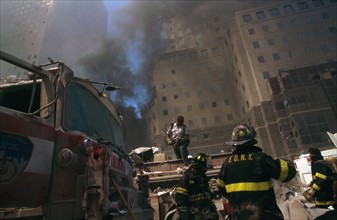 Colour photograph of a New York Fire-fighter amid the rubble of the World Trade Centre following the 9/11 attacks