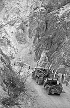Photograph of a US Army Truck towing a Jeep during World War Two