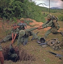 American soldiers uncovering a Vietcong tunnel