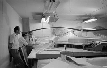 Architect Eero Saarinen studying a scale model of the Trans World Airlines Terminal