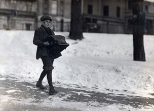 Boy delivering a typewriter