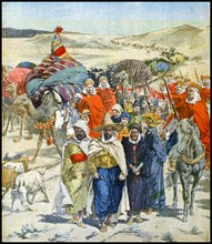 A Razzia or slave raid in caravan formation passing through the Algerian Sahara desert, 1900